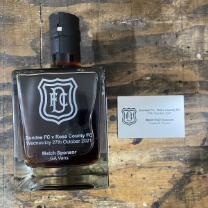 glass gin bothy bottle with dundee football club (DFC) logo and match sponsor laser engraved with a faux metal plaque for the match ball sponsor by the altered state